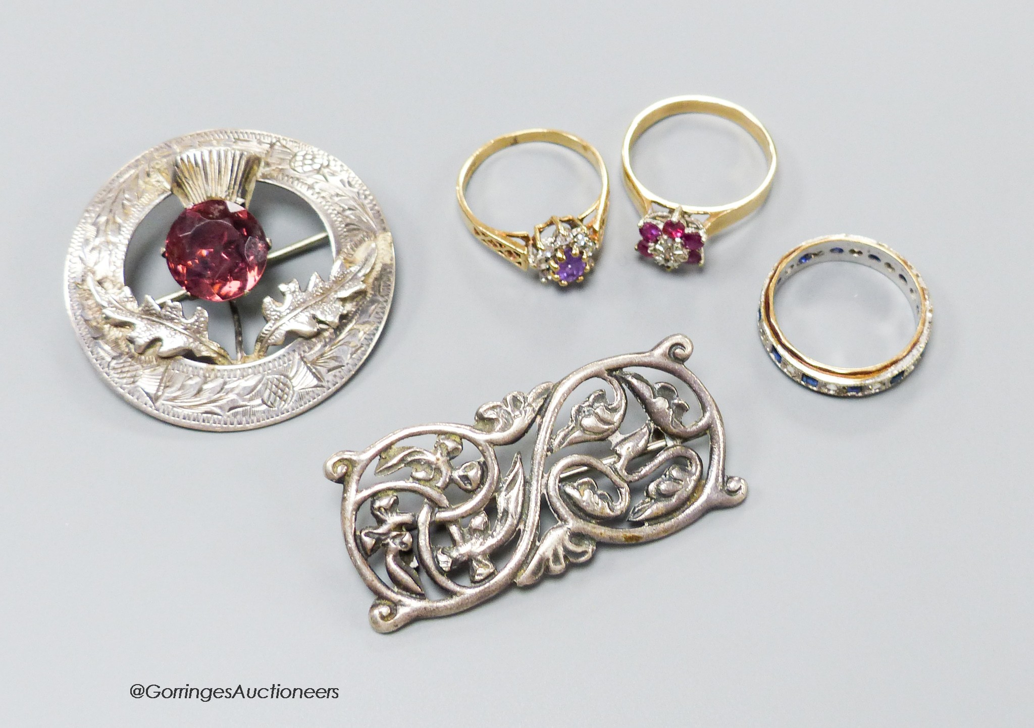 Three assorted modern 9ct gold and gem set dress rings, gross 7.3 grams, a Scottish silver Iona brooch and one other Scottish gem set brooch.